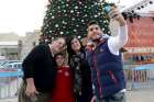 Fadi Hazboun, 20, takes a selfie of with his Catholic family from Nazareth in front of the Christmas tree in Manger Square outside the Church of Nativity in Bethlehem, West Bank, Dec. 21. Pictured with him are his father, Afif, mother, Nardin, and his 8- year-old brother, Jowan.