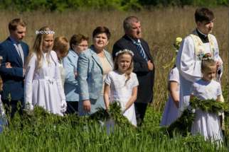 25-year-old Father Tymoteusz Szydlo, far right, celebrated his first Mass May 28. He is the son of Polish prime minister Beata Szydlo, second from right.