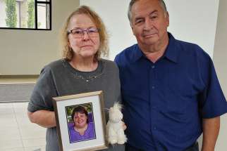 Patricia and Doriano Baisi with a photo of their late daughter Jenny and her favourite stuffed unicorn.