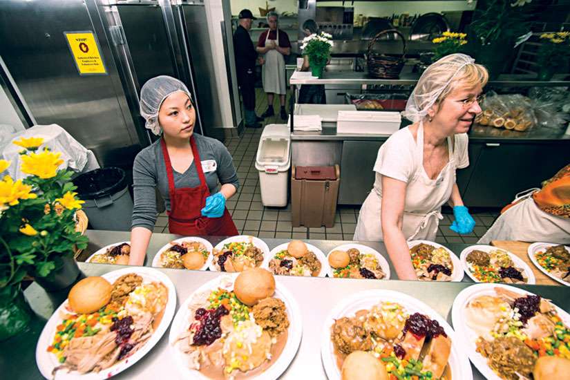 Volunteers prepare the Thanksgiving dinners for patrons of the Good Shepherd Centre in downtown Toronto. The Good Shepherd has recently turned to social media in efforts to raise money for its programs. The hashtag #FastTurkey is aiming to raise $10,000.