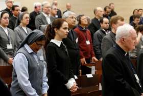 Participants pray at the start of a seminar on safeguarding children at the Pontifical Gregorian University in Rome March 23. An upcoming international congress in Rome in October will focus on the problem of online sexual abuse of minors and how to better safeguard children on the internet.