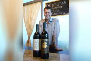 Garrett Busch, CEO of Napa Valley’s Trinitas Cellars, with two wines that honor popes — RatZINger Zinfandel and Cabernet FRANCis.