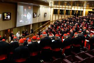 The German, French and Swiss bishops’ conference presidents prepared for the upcoming Synod of Bishops by listening to theologians, scholars and lawyers. In this photo, Pope Francis, cardinals and cardinals-designate pray before a meeting in the synod hall at the Vatican Feb. 12, 2015.
