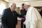 Pope Francis and Palestinian President Mahmoud Abbas speak with the help of a priest translating for them as they meet in the Apostolic Palace at the Vatican Dec. 12, 2024.