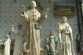 Statues of Pope Francis and his namesake, St. Francis, fill the windows of souvenir stores in Assisi.