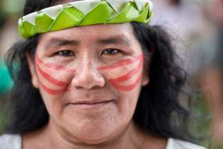 A woman participates in a march of indigenous people through the streets of Atalaia do Norte in Brazil&#039;s Amazon region March 27, 2019. The Vatican was to release the working document for the Synod of Bishops for the Amazon June 17.