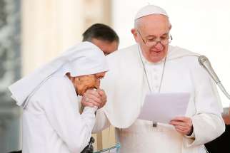 Sister Maria Concetta Esu, an 85-year-old Daughter of St. Joseph, kisses the hand of Pope Francis after the pontiff awarded her the Pro Ecclesia et Pontifice Cross during his general audience in St. Peter&#039;s Square at the Vatican March 27, 2019.