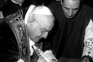 Pope John XXIII signs the bull convoking the Second Vatican Council Dec. 25, 1961. The council’s four sessions and its 16 landmark documents modernized the Church.