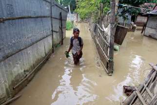 A girl wades through floodwaters near Agartala, India, Sept. 5.