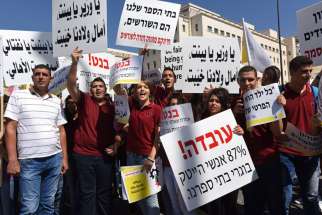  Israeli Arab Christians demonstrate outside Israeli Prime Minister Benjamin Netanyahu&#039;s office in Jerusalem Sept. 6, to protest government budget cuts to their schools.