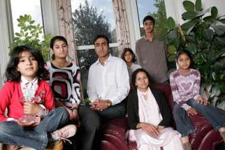 From left to right, Leena, Anniesa, Nissar, Sarah, Kubra, Issar, and Miriam Hussain, a Christian family who have been threatened with death for converting from Islam in West Yorkshire, England.