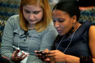 Young women tweet messages during a 2012 conference in Washington. Low-cost video messaging carried across increasingly video-friendly social media platforms will define this year&#039;s World Youth Day experience in Krakow, Poland, say several organizations.