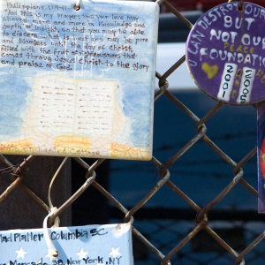 An unofficial memorial of hand-made tiles in New York’s Greenwich Village commemorates the terrorist attacks of Sept. 11, 2001. The tile at the top left quotes St. Paul’s Letter to the Philippians 1:9-11. (Photo by Michael Swan)