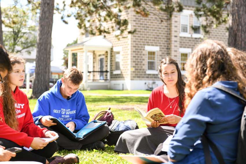 A study group at Our Lady Seat of Wisdom College takes its studies outside at the Barry’s Bay, Ont., school.