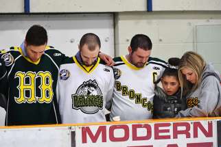 Mourners pray during an April 8 vigil at Elgar Petersen Arena in Humboldt, Saskatchewan, to honor members of the Humboldt Broncos junior hockey team who were killed in a fatal bus accident.