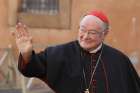 Italian Cardinal Renato Martino waves as he arrives for the first general congregation meeting in the synod hall at the Vatican March 4, 2013.