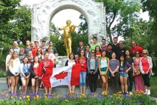 Students pose in front of Mozart’s statue in Vienna during last year’s summer trip.