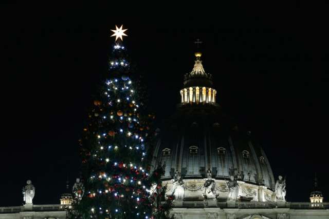 The dome of St. Peter&#039;s Basilica and the Vatican Christmas tree are seen following a lighting ceremony at the Vatican Dec. 18. 