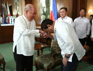 Philippine President Rodrigo Duterte, right, greets Archbishop Romulo Valles of Davao, president of the Catholic Bishops&#039; Conference of the Philippines, before a meeting inside the presidential palace in Manila.  