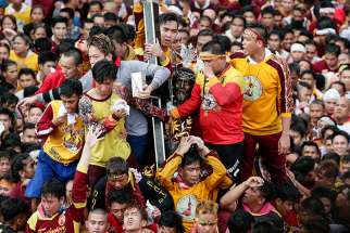  Pilgrims climb to touch the Black Nazarene during Jan. 7 procession in Manila, Philippines. The wooden statue, carved in Mexico and brought to the Philippine capital in the early 17th century, is cherished by Catholics, who believe that touching it can lead to a miracle.