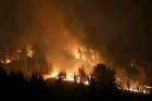 Flames and smoke rise from wildfires Jan. 24 in Empedrado, Chile. Pope Francis sent his condolences to the victims and survivors of one of the worst wildfires in Chile&#039;s history.