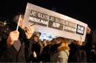 People hold a placard that reads &quot;I am Muslim, I am Jewish, I am Catholic, I am Charlie&quot; during a Jan. 8 vigil in Paris, following the mass shooting at the offices of Charlie Hebdo, a satirical newspaper in Paris. Pope Francis condemned the killings of a t least 12 people at the offices of the publication Jan. 7 and denounced all &quot;physical and moral&quot; obstacles to the peaceful coexistence of nations, religions and cultures.