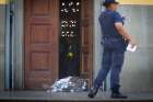 A police officer stands next to a body at the scene of a shooting Dec. 11 at the Metropolitan Cathedral in Campinas, Brazil. Police said Euler Fernando Grandolpho opened fire in the cathedral, killing at least four people and injuring several others before the 49-year-old turned the gun on himself after being shot by police.