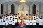 Altar servers, priests of the FSSP and Ottawa Archbishop Terrence Prendergast gather for a photo after a Pontifical High Mass in the Extraordinary Form of the Roman Rite Nov. 23 at Ottawa’s Notre Dame Cathedral. 