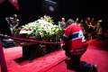 A mourner kneels in front of the casket of Jean Beliveau as he pays his respects to the Montreal Canadiens hockey legend during a public viewing in Montreal Dec. 7.