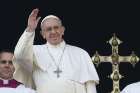 Pope Francis greets the crowd after delivering his Christmas message and blessing &quot;urbi et orbi&quot; (to the city and the world) from the central balcony of St. Peter&#039;s Basilica at the Vatican Dec. 25.