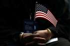 An immigrant holds a U.S. flag during a naturalization ceremony in New York City June 30.