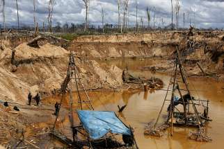 Peruvian police take part in an operation to destroy illegal gold mining camps in 2015 in a zone known as Mega 14, in the southern Amazon region of Madre de Dios, Peru. 