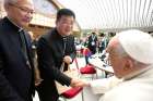 Bishop Joseph Yang Yongqiang of Hangzhou, China, shakes hands with Pope Francis while Bishop Vincent Zhan Silu of Funing-Mindong, the other member of the Synod of Bishops from mainland China, looks on in the Paul VI Audience Hall at the Vatican Oct. 8, 2024.