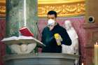 Sacristan Elias Taveras uses a disinfectant as he cleans the ambo between televised Masses at the Co-Cathedral of St. Joseph in Brooklyn, N.Y. For most churches across Canada and the U.S. televised Masses will be the only alternative for parishioners for the time being.