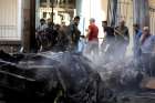 People gather at the site of a car bomb blast outside the Syriac Orthodox Church of the Blessed Virgin Mary in Qamishli, Syria, July 11, 2019. At least 11 people were injured in the blast during evening service. It was unclear who was responsible for the attack.