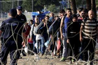 Migrants enter Macedonia near Gevgelija after crossing the border with Greece Sept. 1. Catholic aid agencies have urged Europeans not to turn against migrants seeking refuge from Syria and other countries, in what media reports describe as the continent&#039;s greatest refugee movement since World War II.