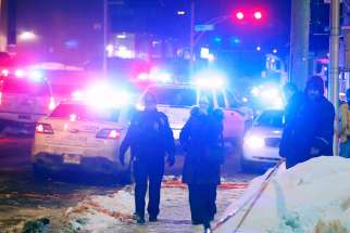 Police officers are seen near a mosque after a shooting in Quebec Jan. 29.