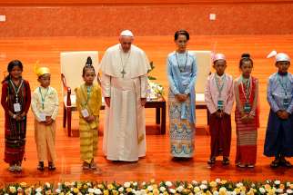 Pope Francis and Aung San Suu Kyi, state counselor and foreign minister of Myanmar, are picture with children before a meeting of government authorities, members of civil society and the diplomatic corps at the Myanmar International Convention Center in Naypyitaw, Myanmar, Nov. 28. 
