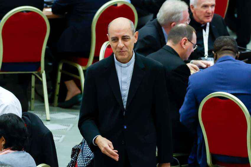 Cardinal Víctor Manuel Fernández, prefect of the Dicastery for the Doctrine of the Faith, arrives in the Paul VI Audience Hall to attend a morning session of the synod at the Vatican Oct. 21, 2024.