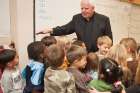 Retired Archbishop Joseph MacNeil of Edmonton, Alberta, is pictured with students in an undated photo. Archbishop MacNeil died Feb. 11 after a stroke.