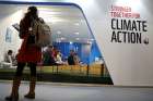 A woman watches an exhibition inside the venue of the U.N. climate change conference, or COP24, Dec. 8 in Katowice, Poland. 