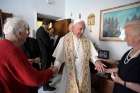 Pope Francis greets residents as he gives an Easter blessing to a home in a public housing complex in Ostia, a Rome suburb on the Mediterranean Sea, May 19. Continuing his Mercy Friday visits, the Pope blessed a dozen homes in Ostia.