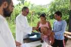 In this 2014 file photo, Father Miguel Angel Cadenas, a Spanish Augustinian missionary, baptizes an infant in an Urarina indigenous community on Peru&#039;s Urituyacu River.