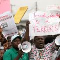 Protesters hold placards and shout slogans in Lagos, Nigeria, Jan. 3. Hundreds of demonstrators closed gas stations, formed human barriers along motorways and hijacked buses in protest against the doubling of fuel prices after a government subsidy was re moved. 