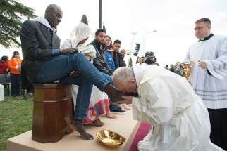 Pope Francis kisses the foot of a refugee during Holy Thursday Mass of the Lord&#039;s Supper at the Center for Asylum Seekers in Castelnuovo di Porto, about 15 miles north of Rome March 24. The Pope washed and kissed the feet of refugees, including Muslims, Hindus and Copts.