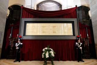 Carabinieri police officers stand guard in front of the shroud in Turin, Italy, May 2, 2012.