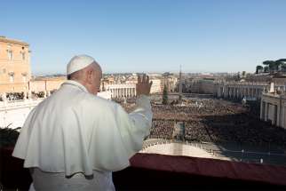 Pope Francis greets the crowd as he leads his Christmas message and blessing &quot;urbi et orbi&quot; (to the city and the world) from the central balcony of St. Peter&#039;s Basilica at the Vatican Dec. 25, 2019.
