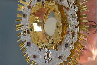  A Catholic Sorb holds the monstrance during the annual Corpus Christi procession May 31 in Crostwitz, Germany.