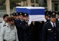 Members of the Knesset guard Jan. 12 carry the flag-draped coffin with the body of former Israeli Prime Minister Ariel Sharon to the Knesset, Israel&#039;s parliament, in Jerusalem, where he lay in state before his funeral. Sharon, who had been in a coma for eight years after he had a stroke at the height of his power, died Jan. 11 at age 85.