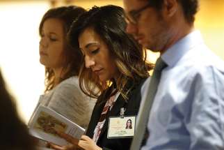  Yadira Vieyra, center, a synod delegate who works with migrant families in Chicago, attends a session of the Synod of Bishops on young people, the faith and vocational discernment at the Vatican Oct. 11. 